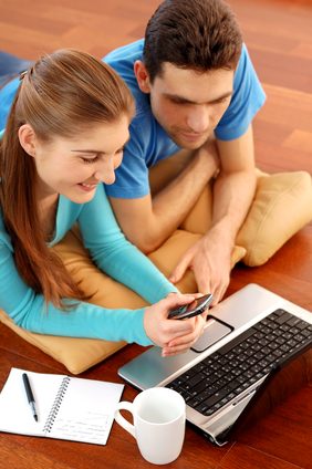 Young couple using laptop at home